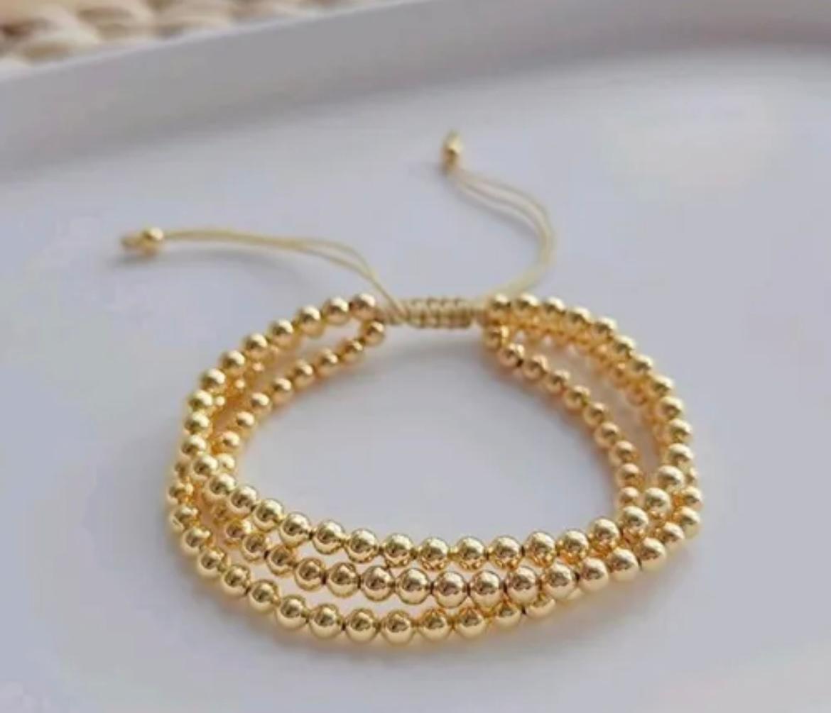 Pulsera triple de bolitas doradas